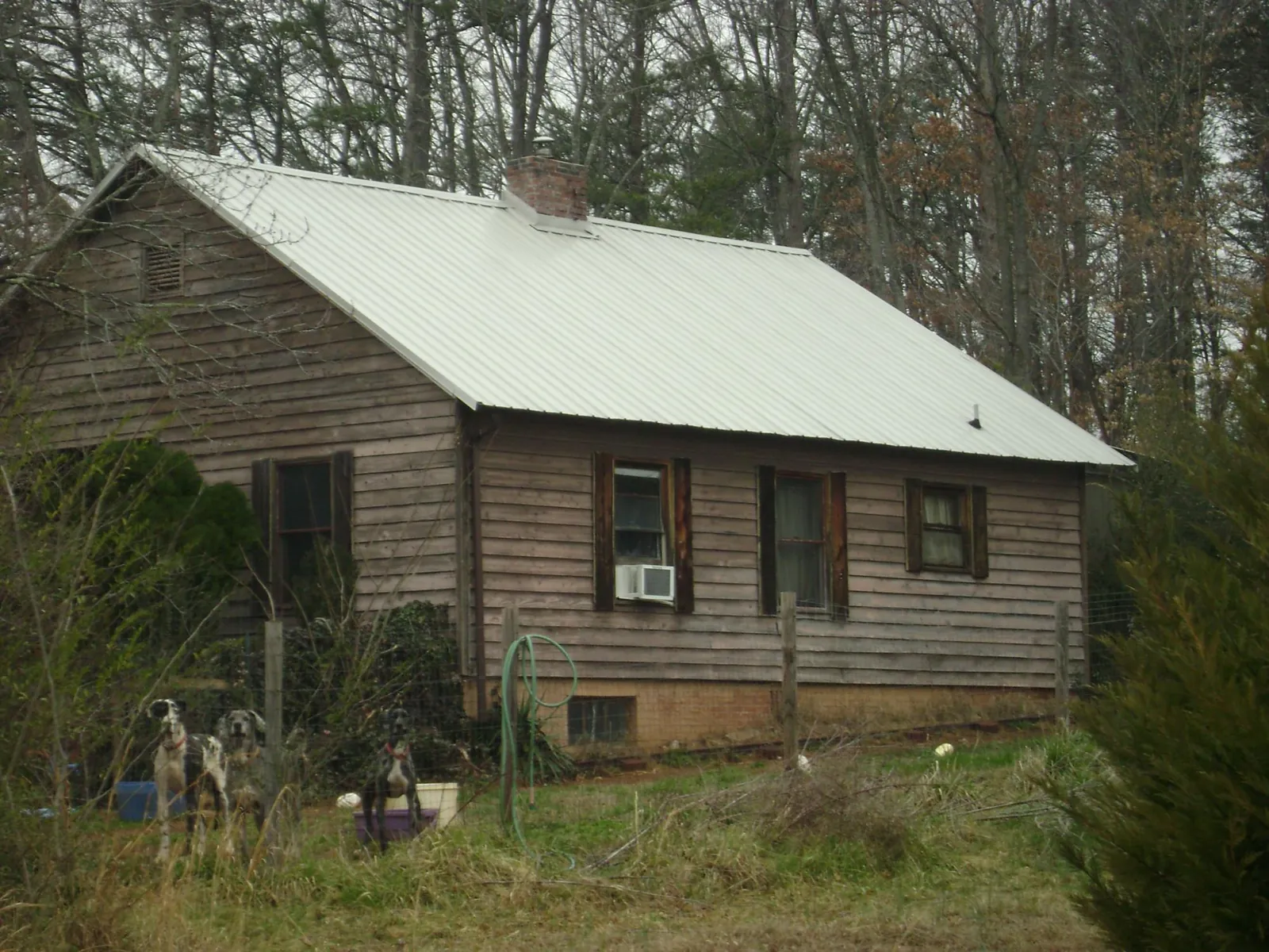 White metal roof on an old wood sided farmhouse, from a Metal Roof Installation job in Kingston